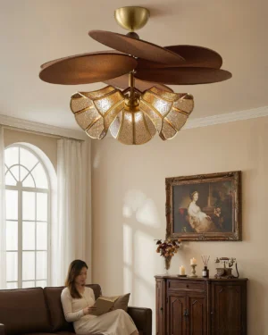 Lucca chandelier in French vintage living room with warm brass finish and soft ambient lighting over leather sofa