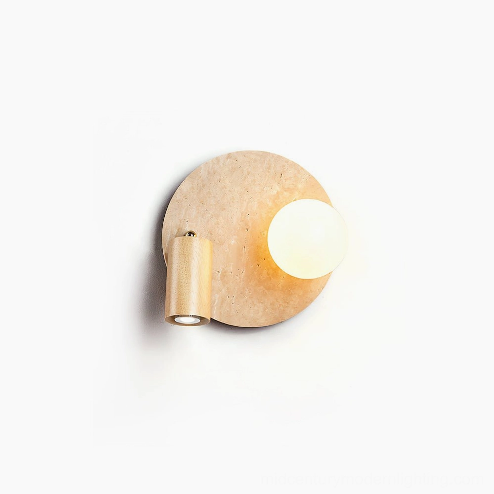 Luka Travertine Wall Lamp - modern sculptural circular backplate in natural beige travertine with frosted glass orb and wooden arm in minimalist studio setting