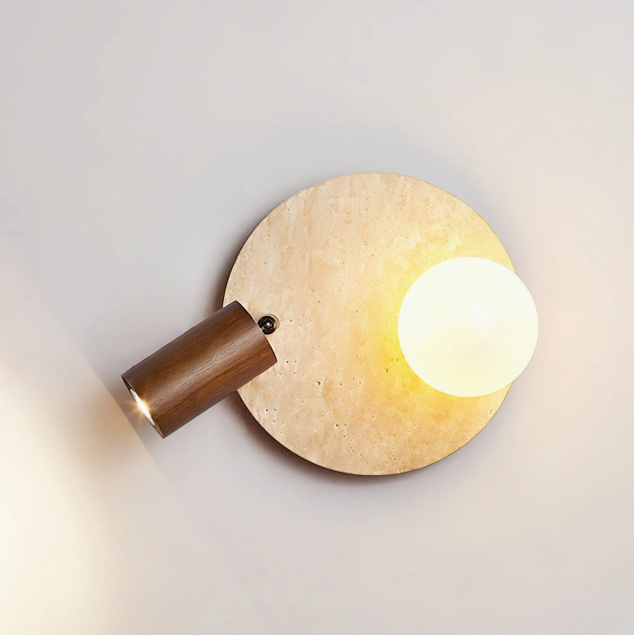 Luka Travertine Wall Lamp low frontal angle with frosted glass orb illuminated showing directional lighting and sculptural form