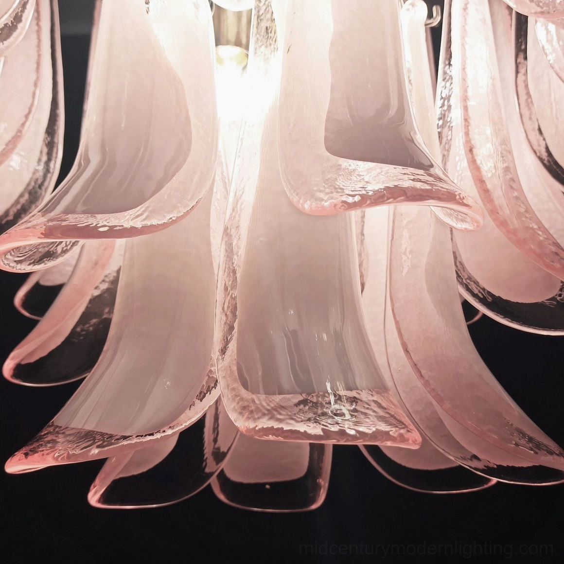 Close-up detail of Luna chandelier's hand-blown pink glass petals with translucent gradient effect