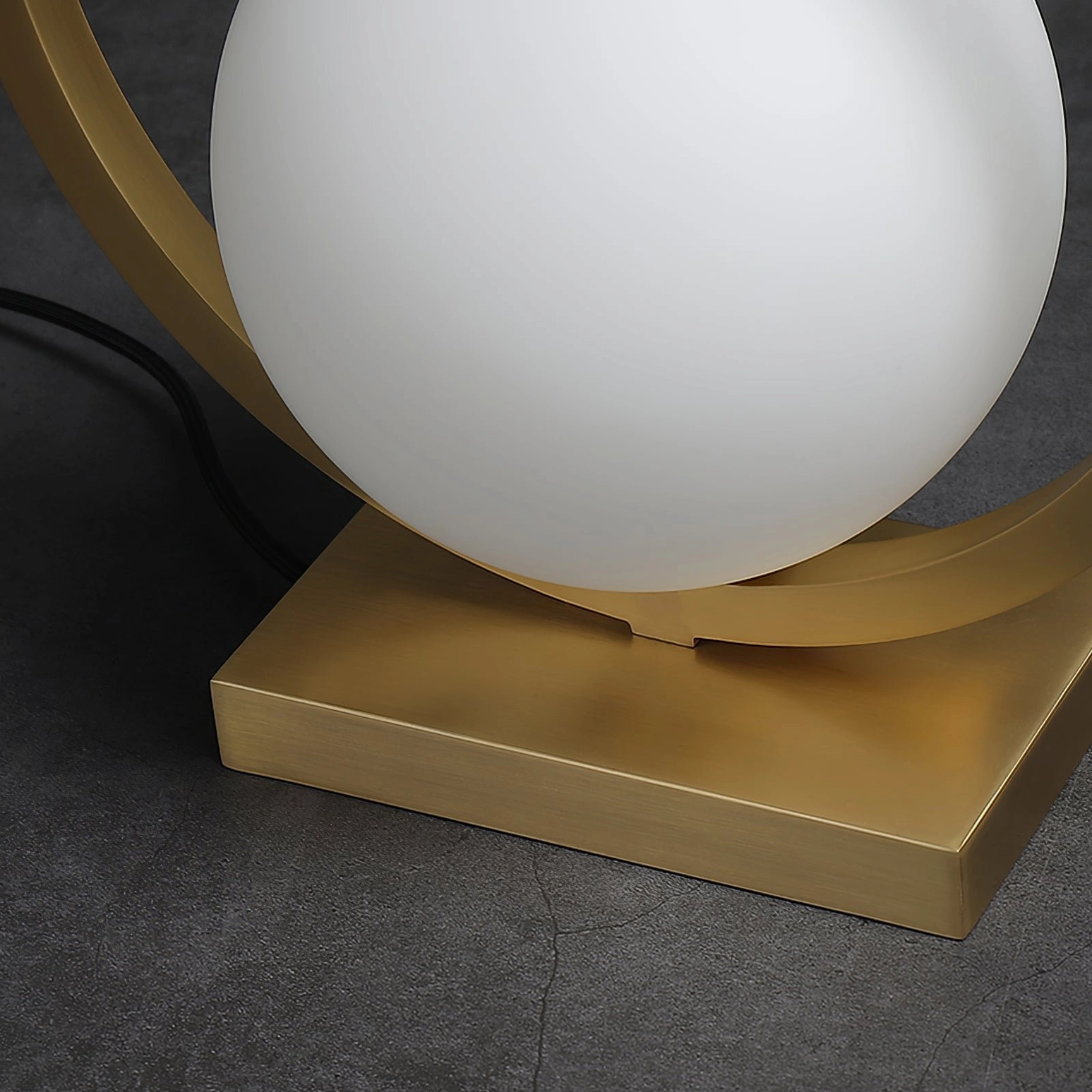 Art deco inspired brass table lamp showcasing circular frame design and frosted glass aesthetic