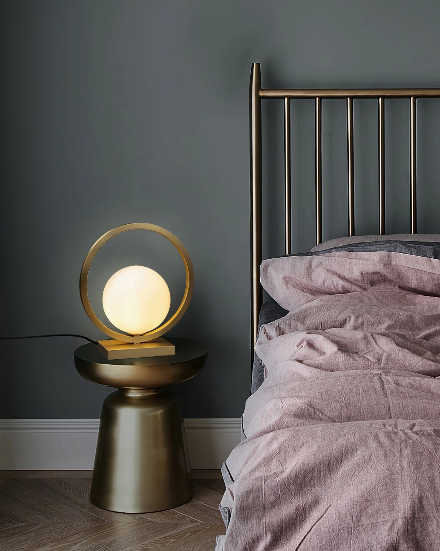 Lunar Brass Table Lamp on modern bedroom nightstand with pink bedding creating contemporary luxury ambiance