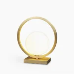 Lunar Brass Table Lamp with frosted white glass globe and circular brass frame on white background
