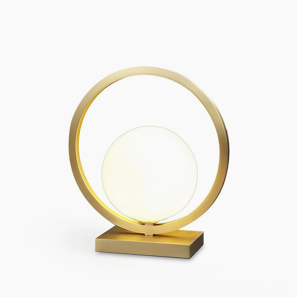 Lunar Brass Table Lamp with frosted white glass globe and circular brass frame on white background
