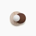 Lunar Eclipse wall sconce dual-sphere design with frosted glass and travertine base - studio flat lay view