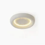 Lunar Glow LED ceiling lamp with textured moon crater surface and warm annular LED backlight, top-down studio view