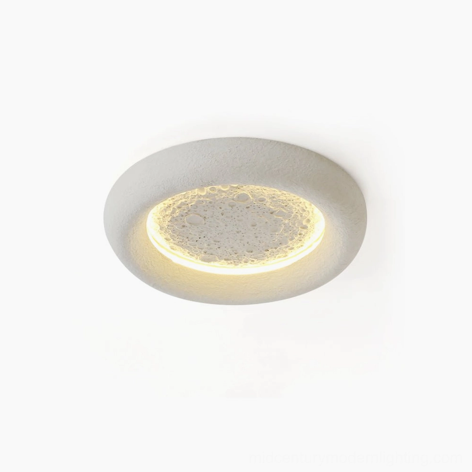 Lunar Glow LED ceiling lamp with textured moon crater surface and warm annular LED backlight, top-down studio view