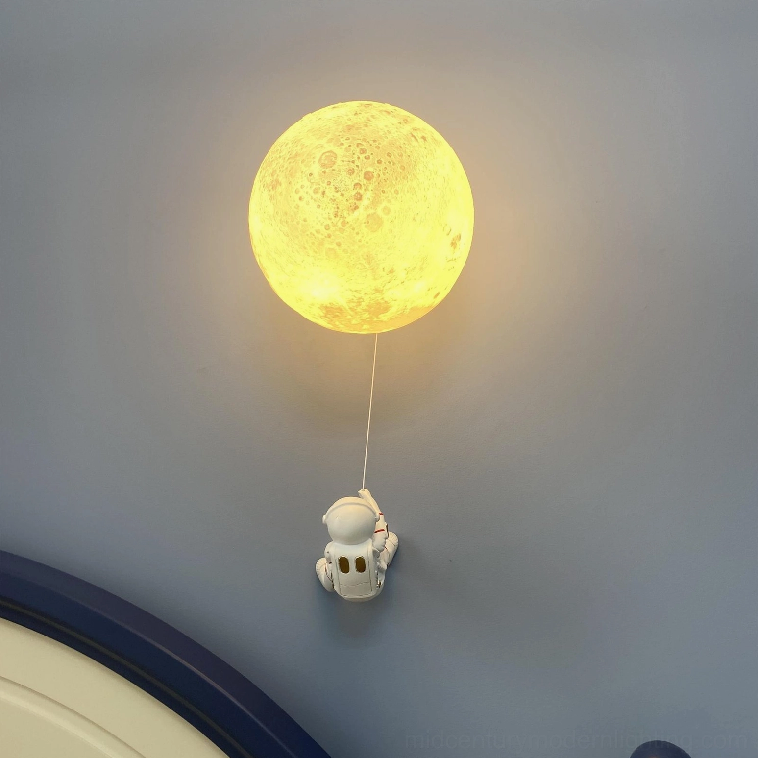 White lunar wall lamp in minimalist Scandinavian interior with natural wood decor