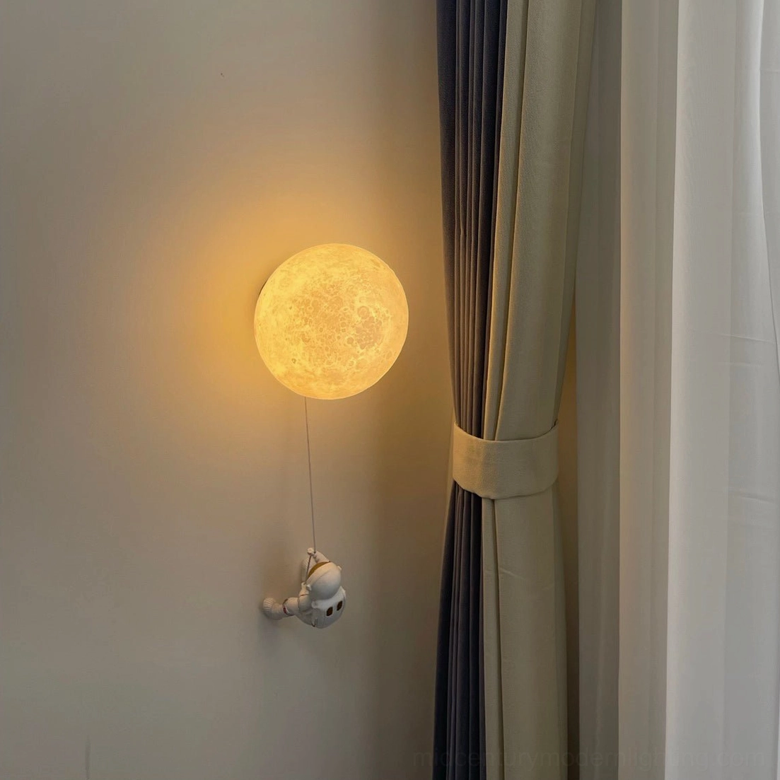 Ambient lunar wall lamp casting warm yellow light over fabric curtain background