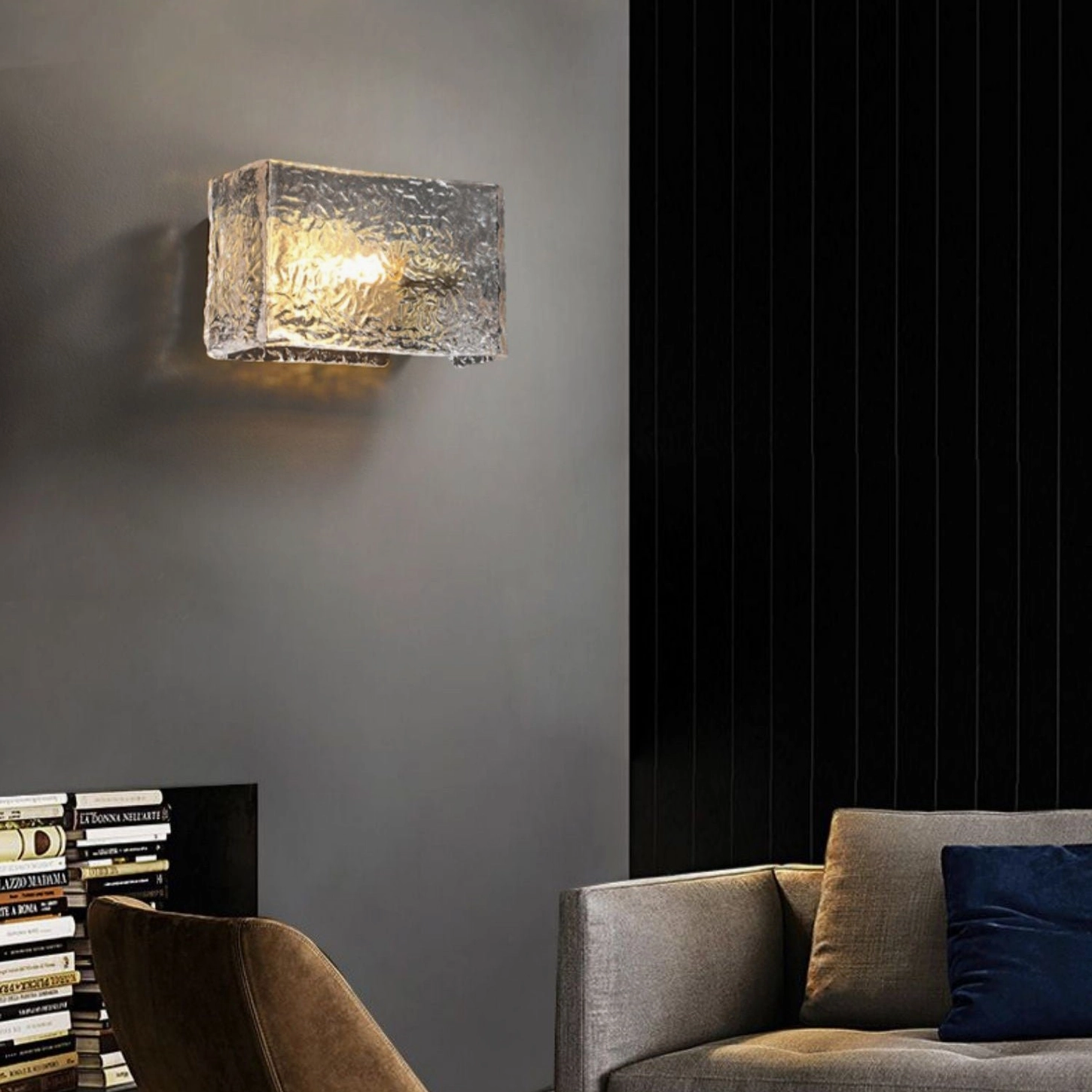 Lunea geometric brass wall sconce in minimalist living room setting on dark wall, frontal view