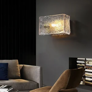 Lunea wall lamp mounted on dark grey living room wall, eye-level side view with warm ambient lighting