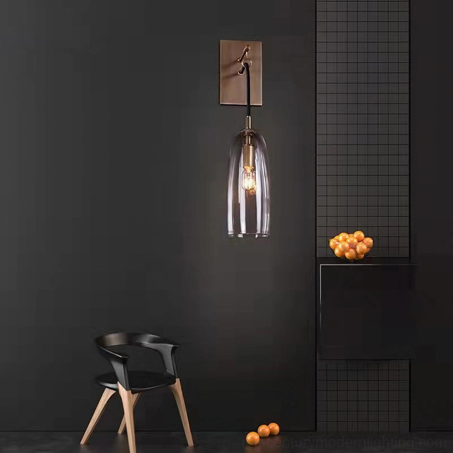 Lure wall sconce detail view showing polished brass hardware and clear glass construction