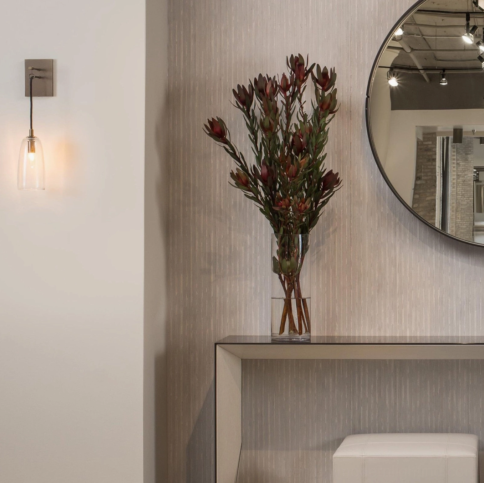 Brass and glass wall sconce detail showing tapered shade design and mounting hardware