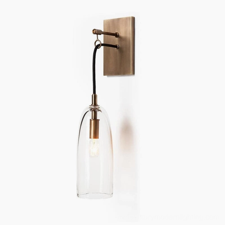 Minimalist wall sconce showcasing tapered glass design paired with warm brass finish