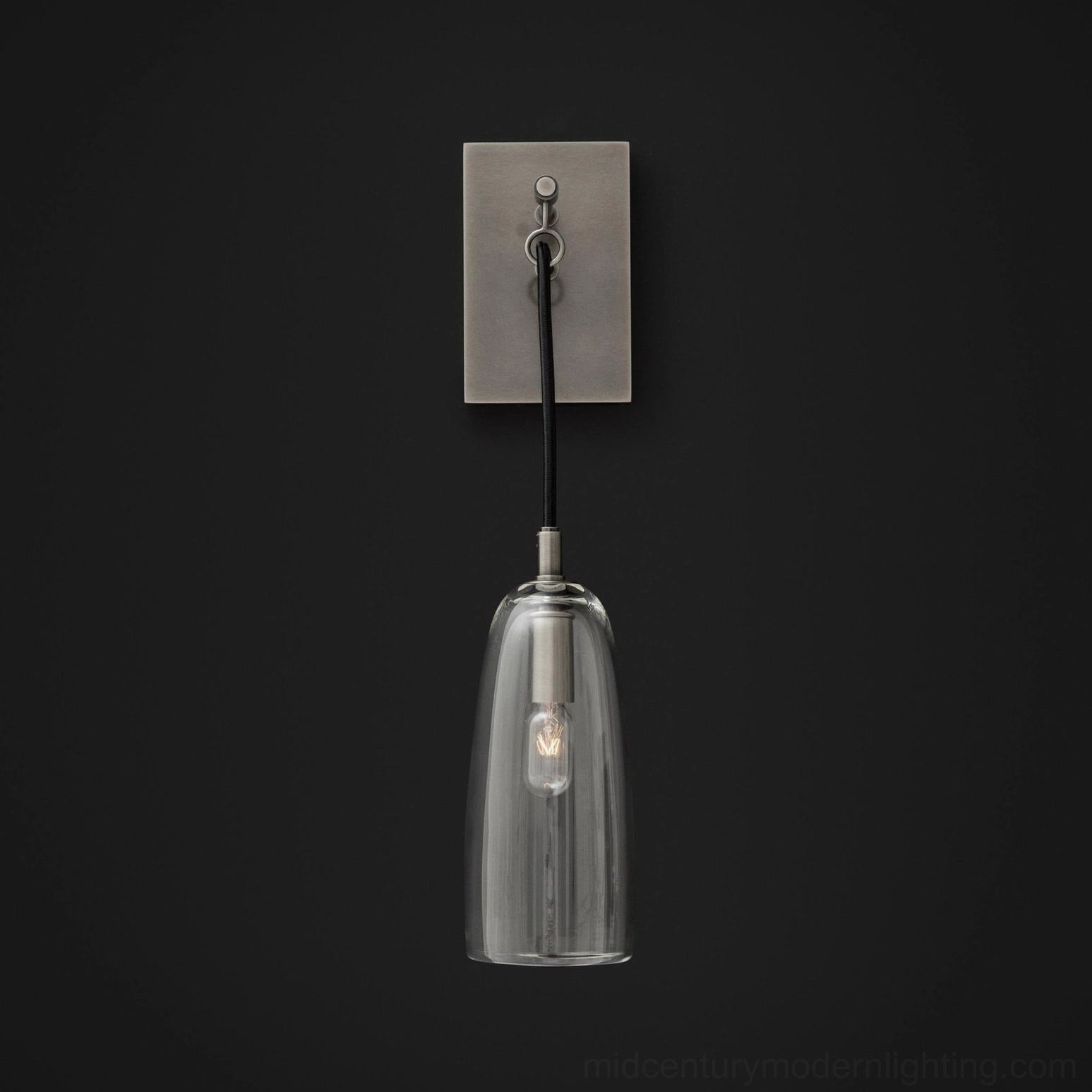 Minimalist brass wall sconce casting directional light in modern home interior design