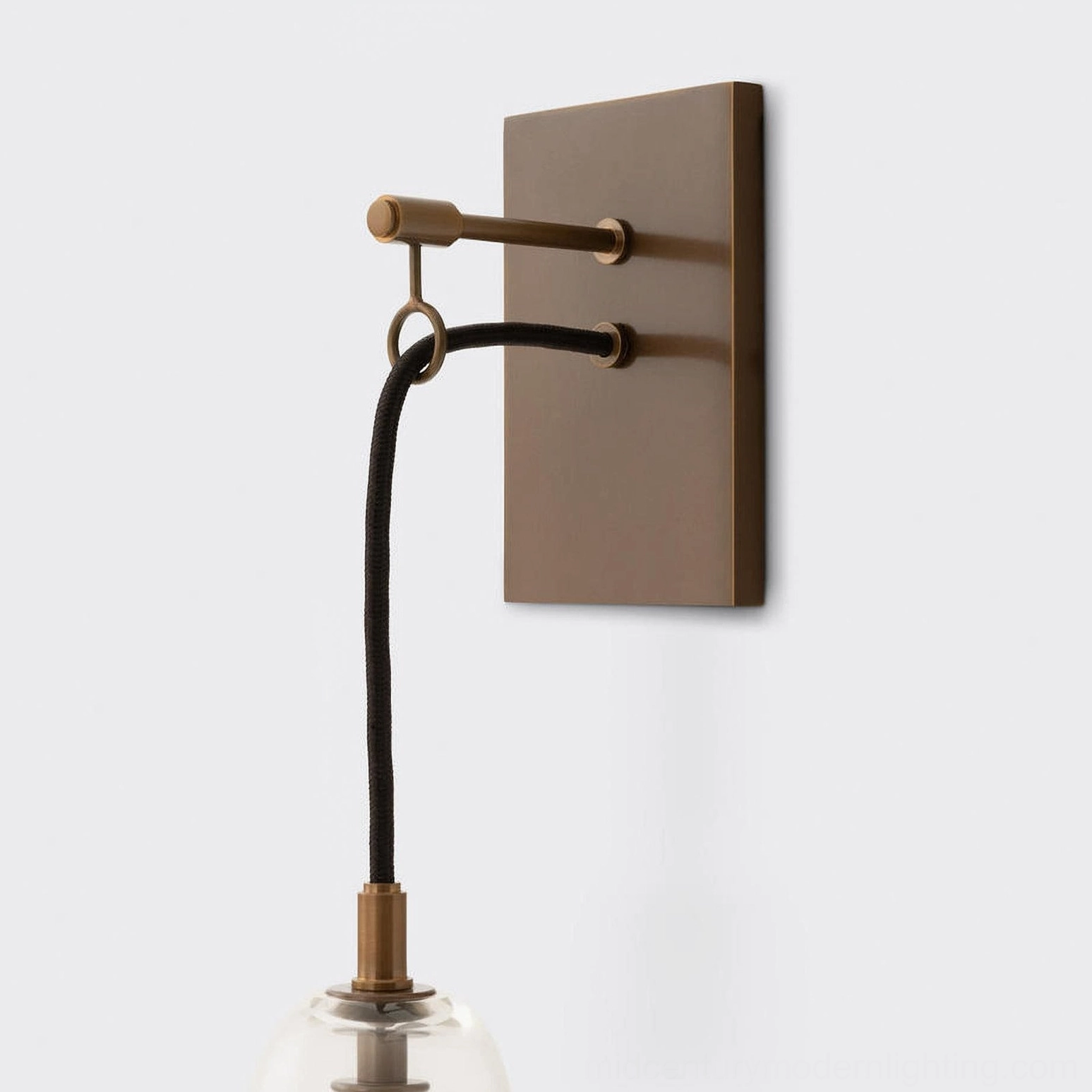 Polished brass wall-mounted sconce with warm white LED or filament bulb, modern lighting solution