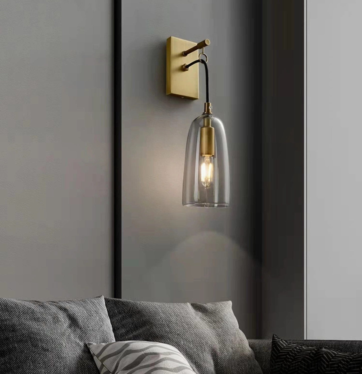 Modern living room wall sconce above grey accent wall with contemporary furnishings