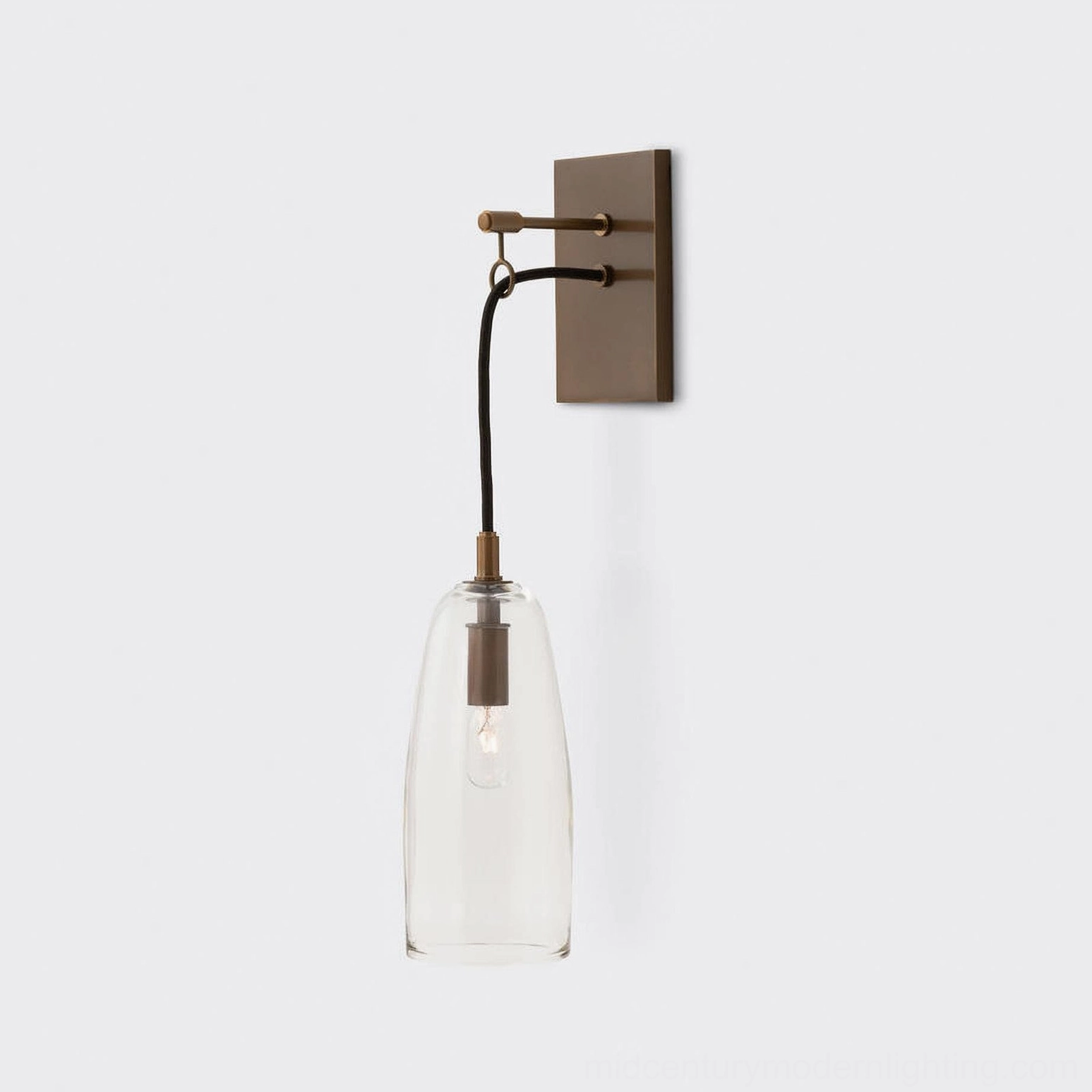Contemporary brass and glass wall sconce reflecting mid-century modern design principles