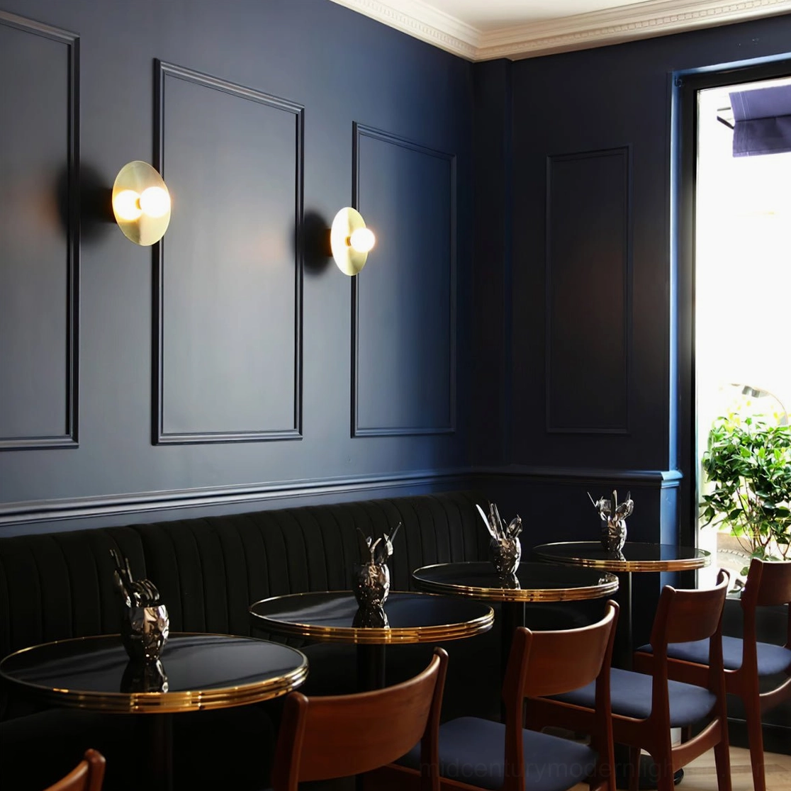 Double disc and sphere wall sconces with frosted glass in upscale modern restaurant
