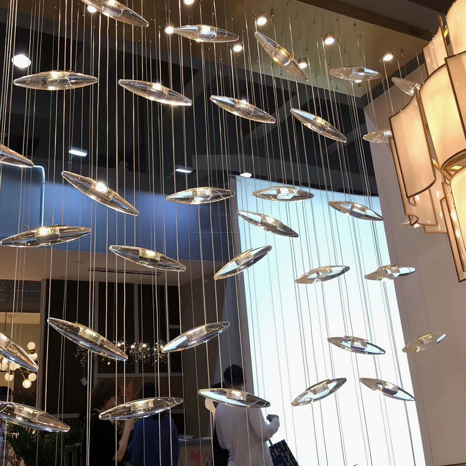 Luxury glass pendant chandelier with cascading design in refined mid-century modern style