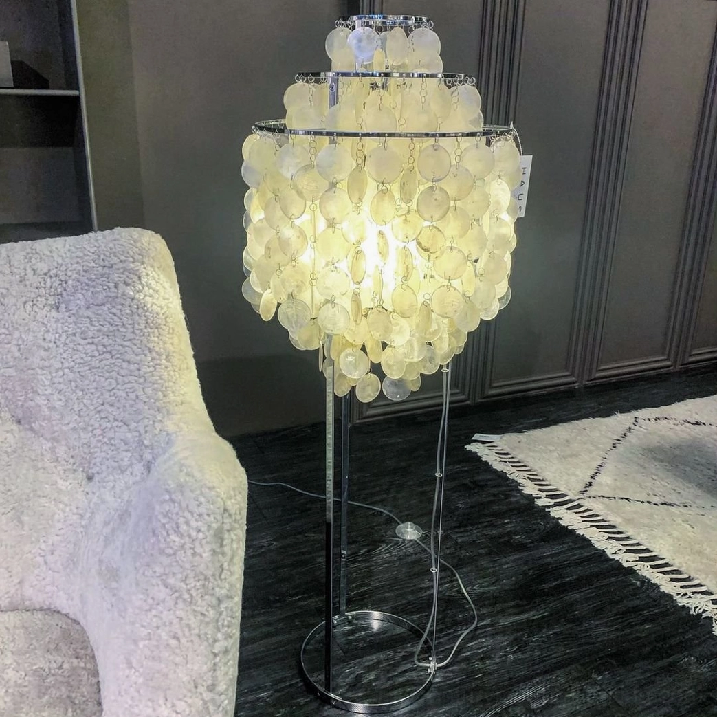 Luxury shell floor lamp with fully illuminated large tiered capiz shells casting soft warm ambient light