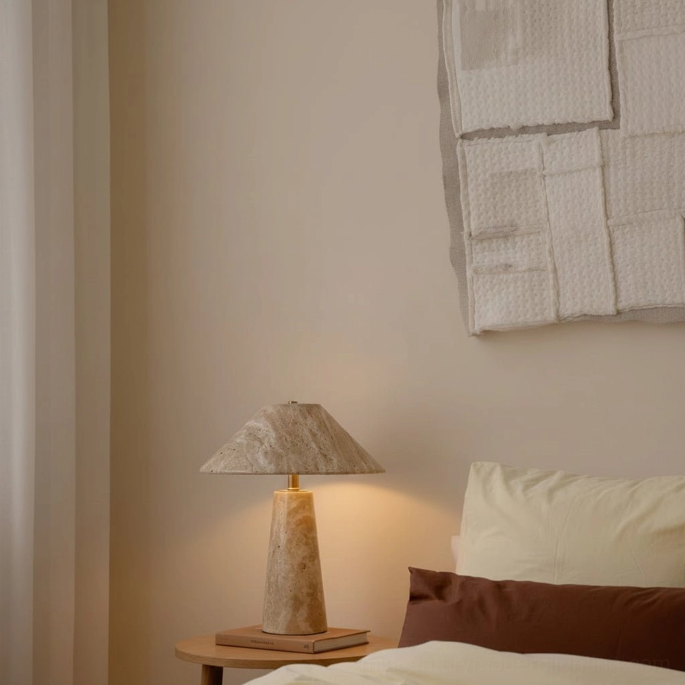 Lydia travertine bedside lamp low angle view on wood nightstand in cozy neutral bedroom setting
