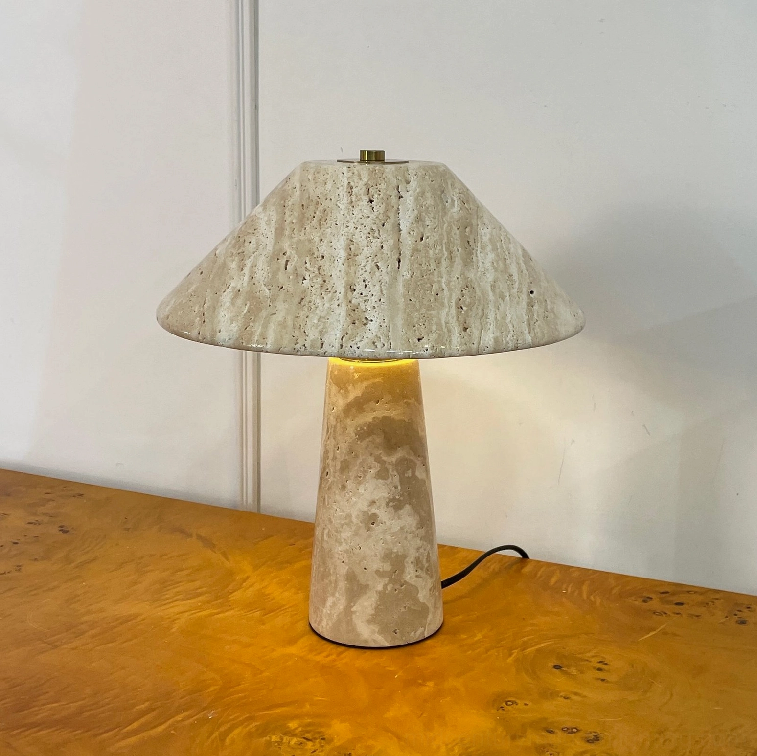 Lydia travertine lamp unlit clean minimalist display on burl wood table with white wall background