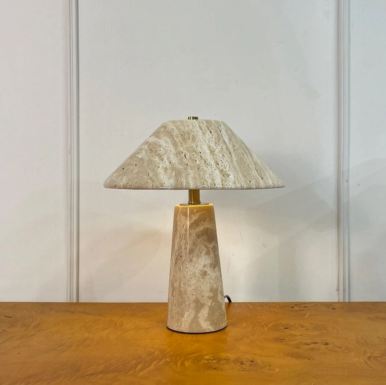 Lydia stone table lamp front view unlit on wood table with paneled white wall neutral interior styling