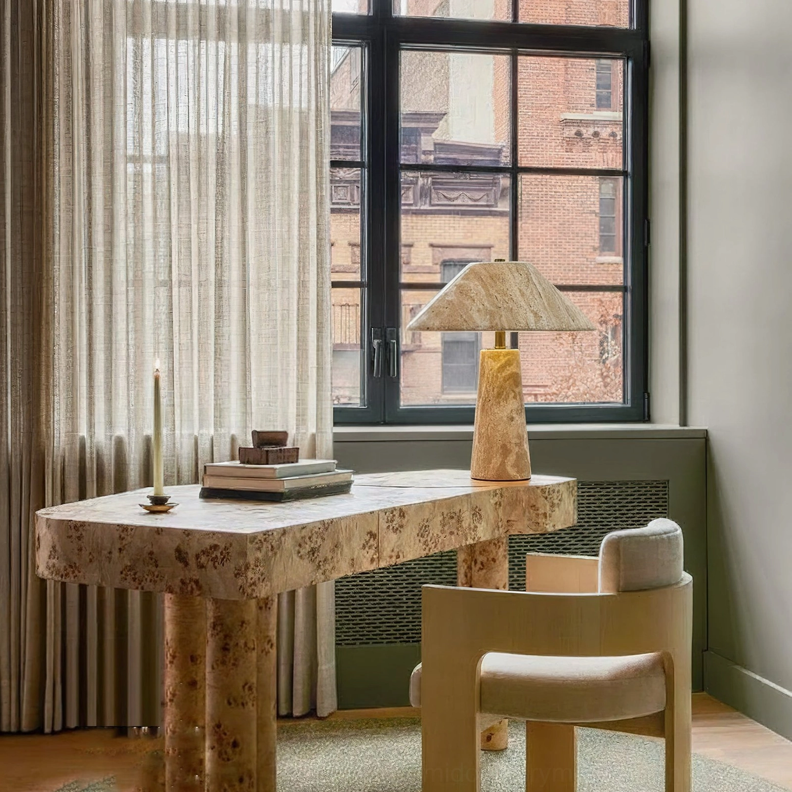 Lydia stone lamp side perspective in minimalist home office with matching travertine desk and natural lighting