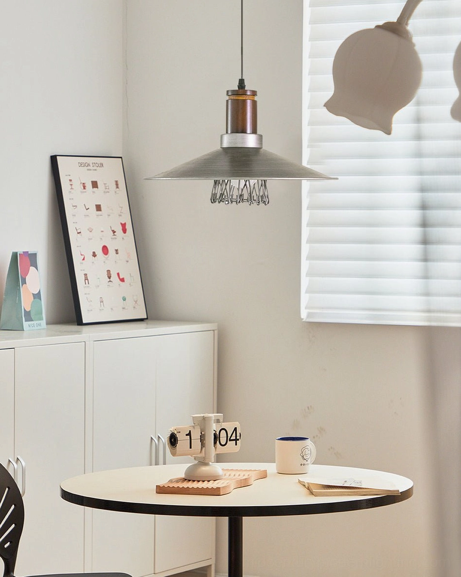 Lyfa industrial pendant light hung above round dining table in minimalist home dining area
