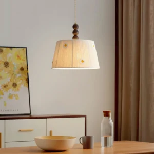Lytham handcrafted daisy pendant light installed over residential dining table with warm wood finial detail