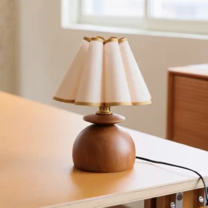 Mabel table lamp three-quarter angle on home office desk with brass hardware details and warm lighting