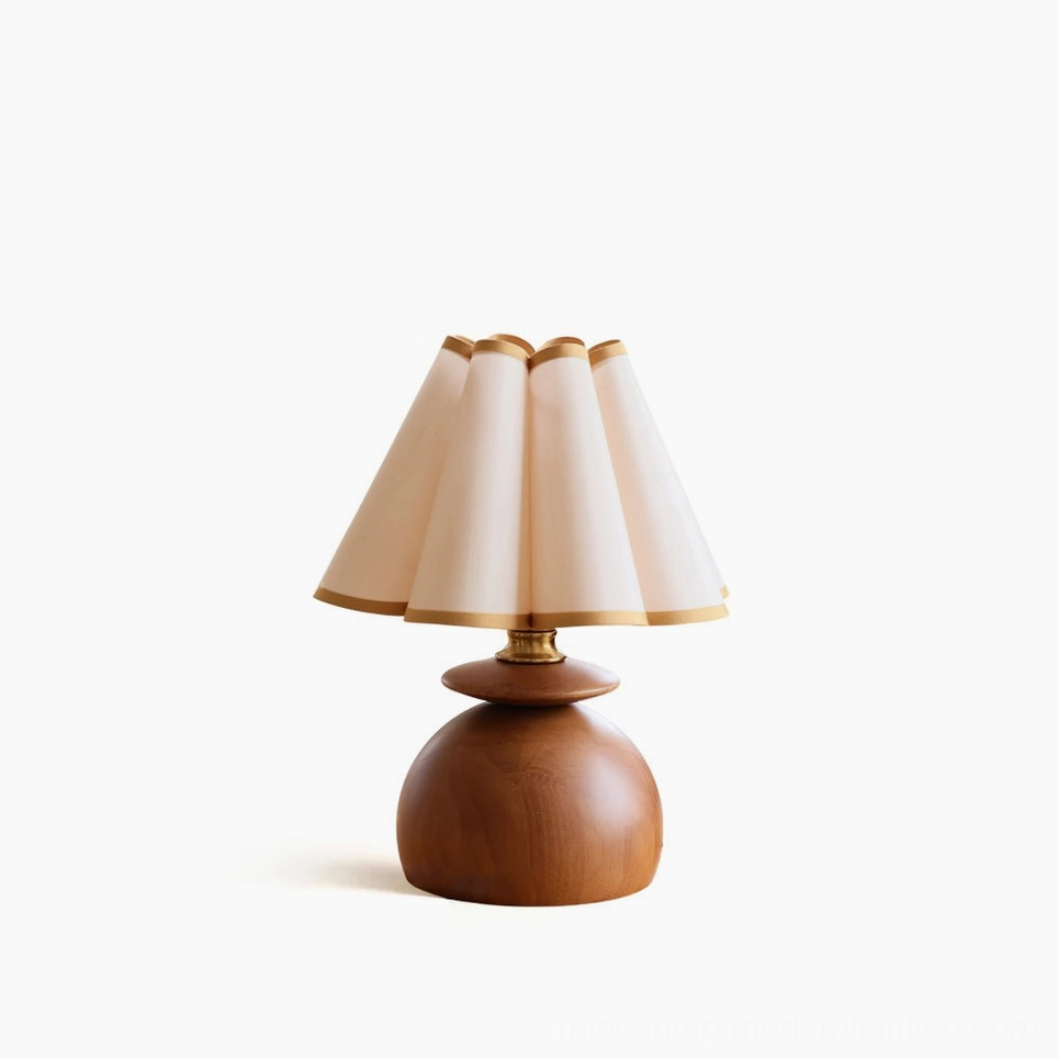 Mabel pleated table lamp front view studio shot showing fabric shade with gold trim and walnut wood base