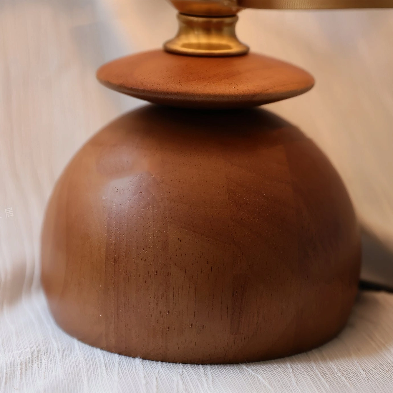 Mabel table lamp walnut wood base close-up overhead view polished brass metal fitting detail