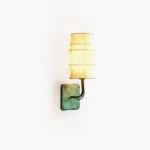 Maeve Lantern Wall Sconce with verdigris metal base and tiered fabric shade, front view