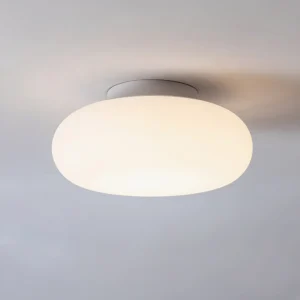 Maga Ellipsoid ceiling light glowing warm white light, close-up overhead view showing soft diffused illumination