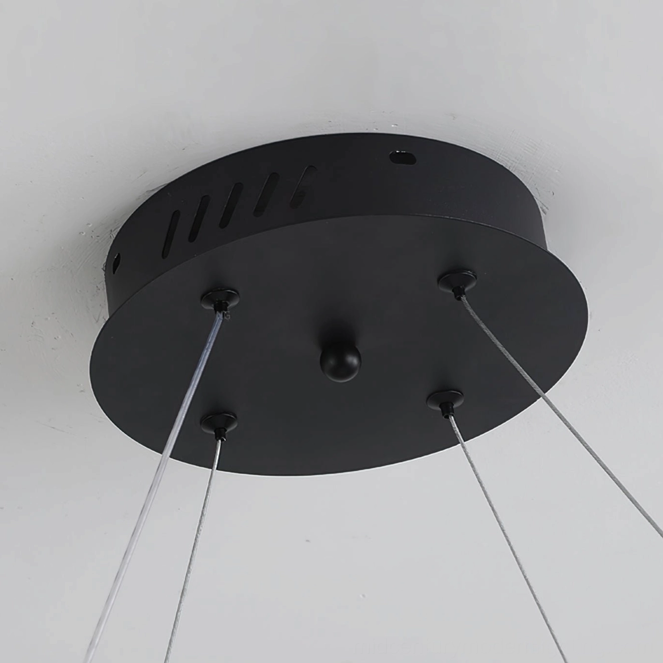 Matte black ceiling canopy with adjustable suspension wires for magnetic bubble chandelier installation