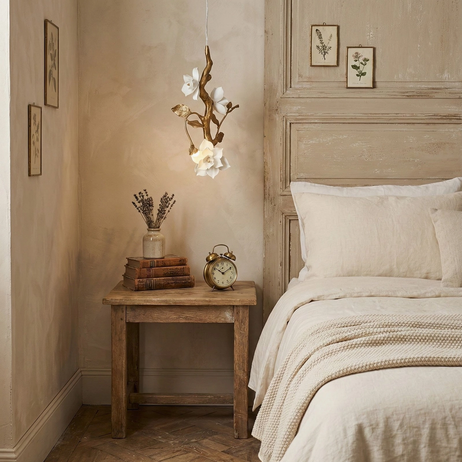 Floral ceiling pendant light illuminating French master bedroom with wall art prints and rustic wooden nightstand