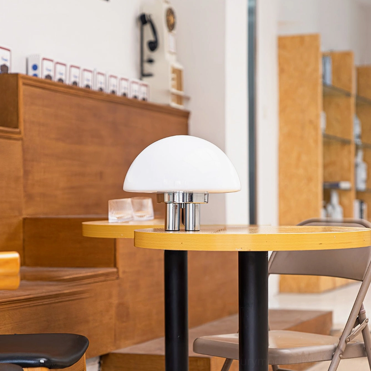 Mid-century modern mushroom table lamp in cafe shop with wooden furniture and seating
