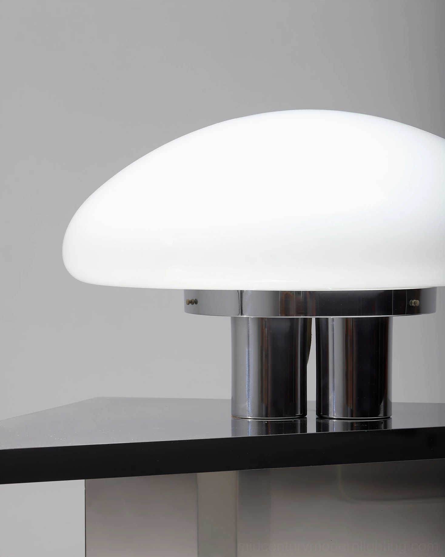 Modern minimalist mushroom table lamp with polished chrome finish and soft diffused lighting