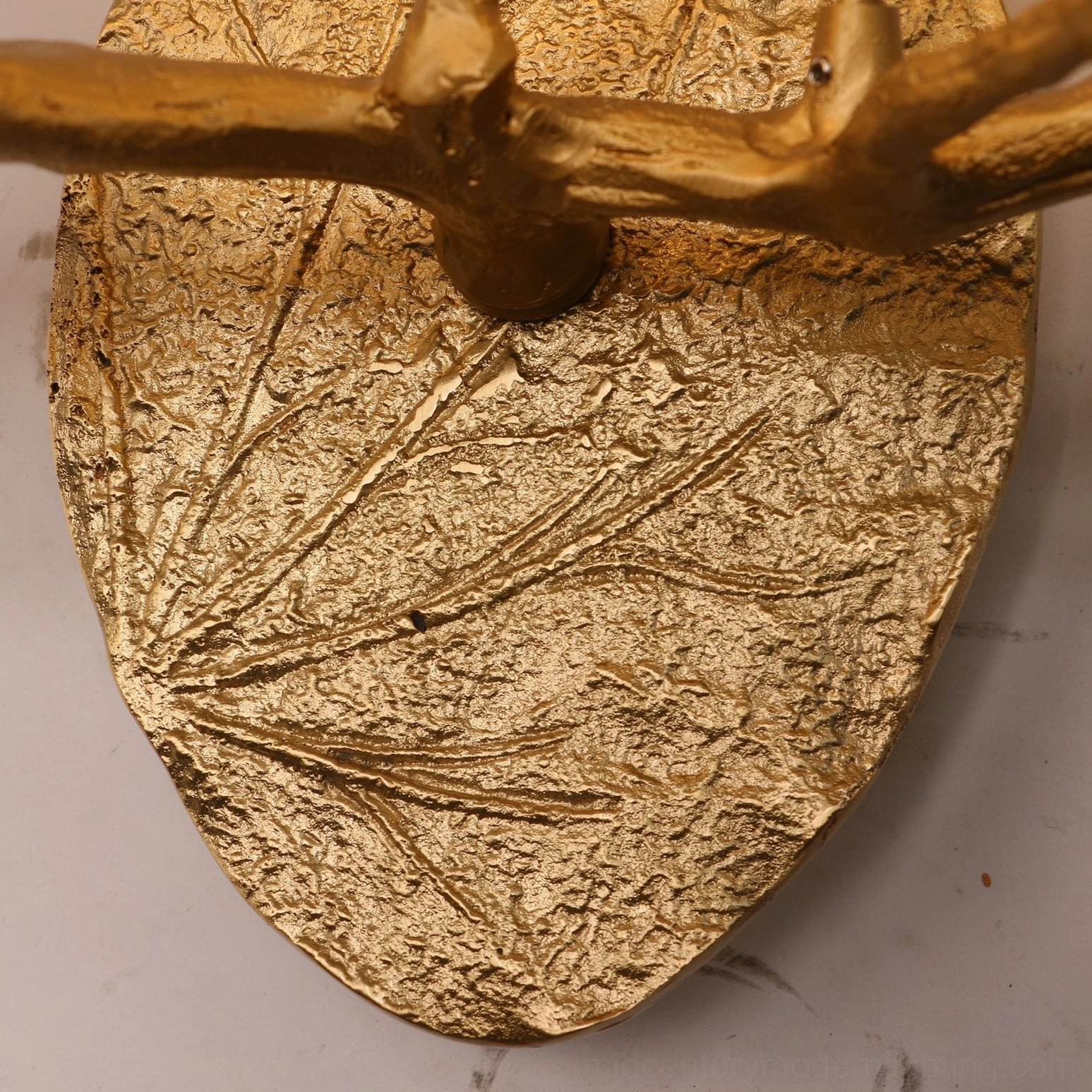 Magnolia leaf brass wall sconce hand-cast botanical lighting fixture detail shot showing glass leaf form and brass branch