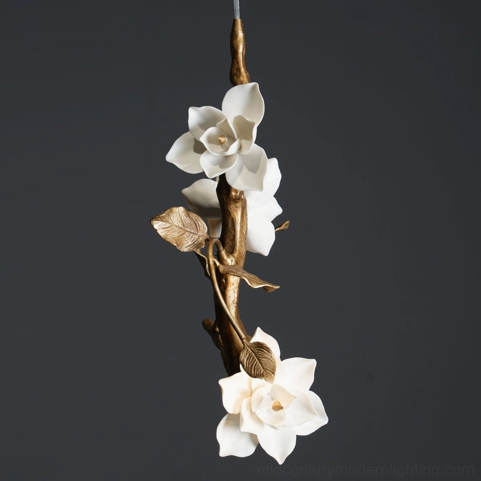 Close-up front view of magnolia pendant light showing gilt metal branch framework and white ceramic flower details