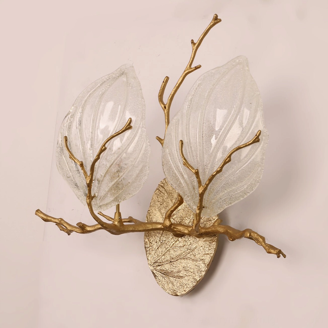 Magnolia leaf branch sconce mounted in contemporary interior showing sculptural form and mid-century modern styling