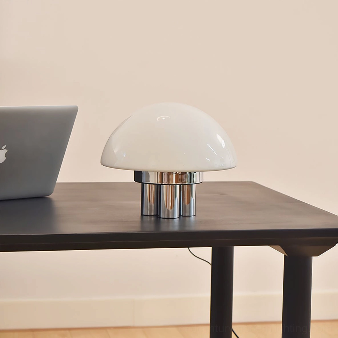 Modern chrome mushroom lamp on home office desk with laptop contemporary workspace