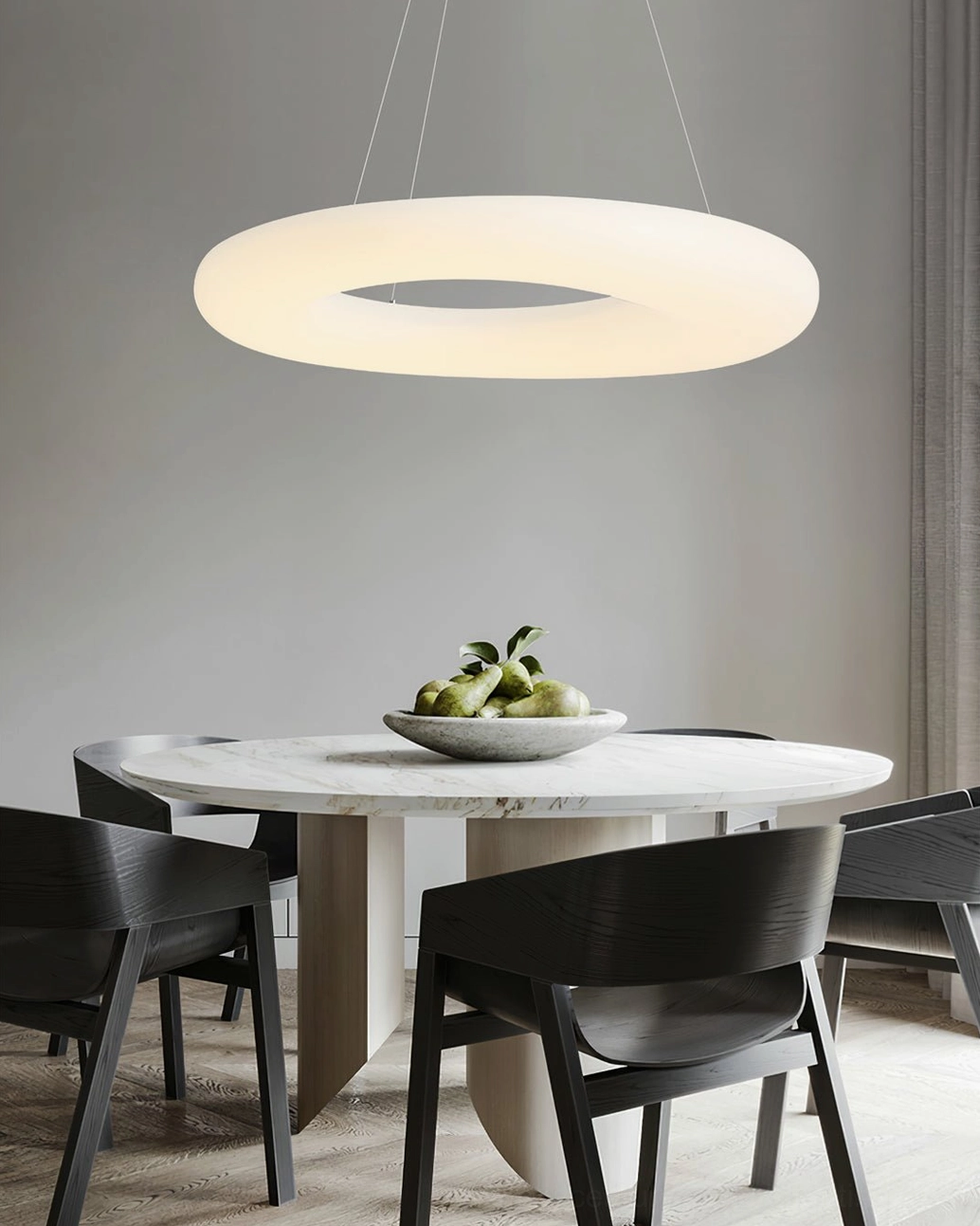 Three-color changing Magoo pendant lamp in neutral light tone above dining area