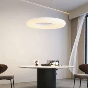 Magoo LED pendant lamp illuminated above modern dining table in warm light setting