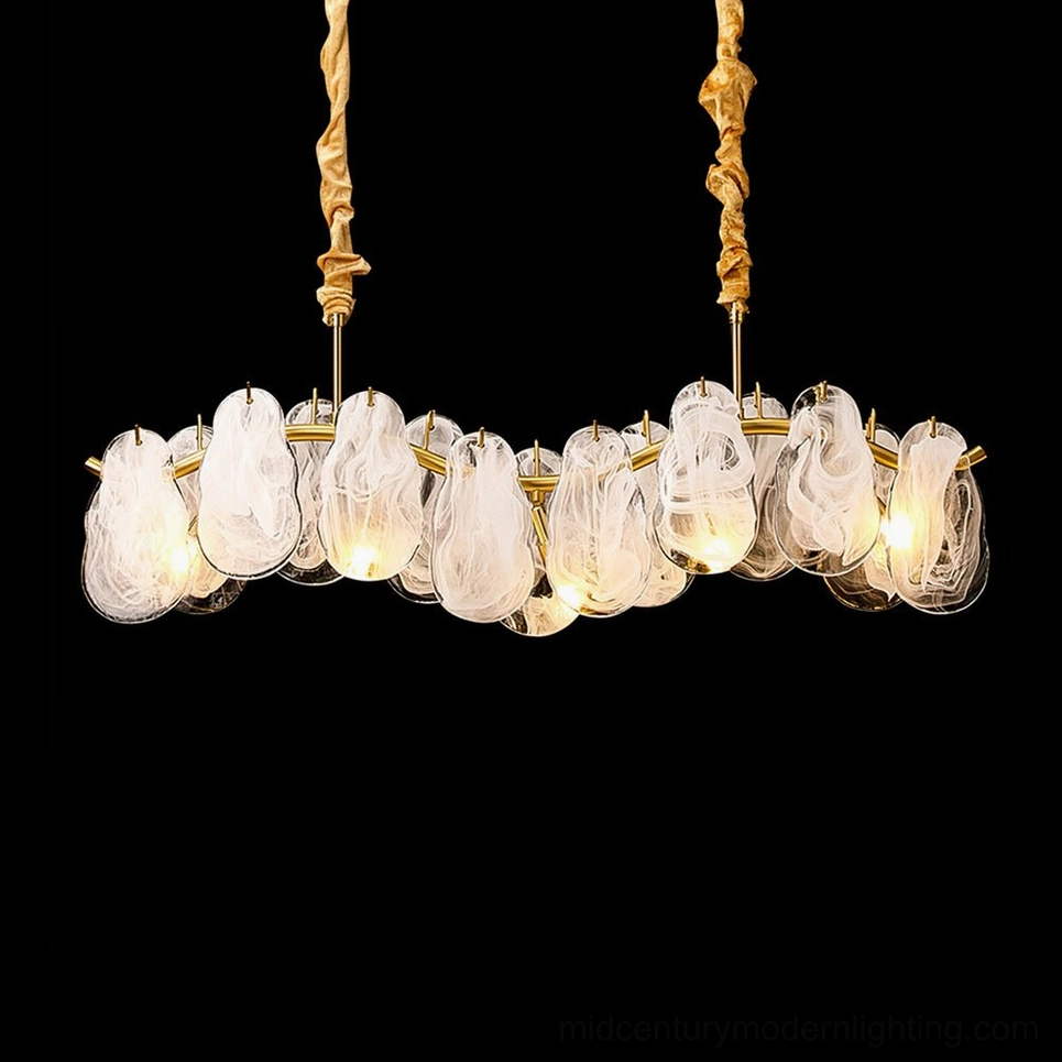 Mahina Cloud sculptural glass chandelier photographed on black background highlighting elegant brushed brass framework and cloud texture detail
