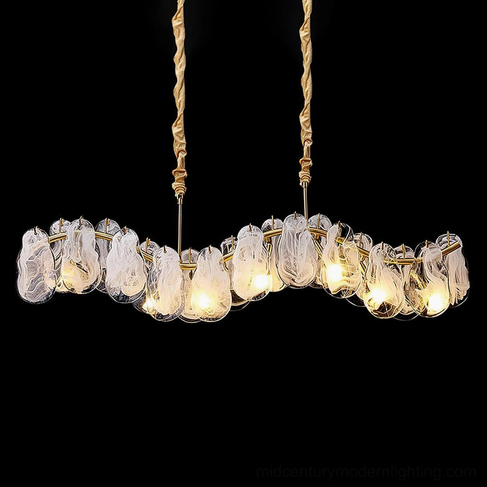 Mahina Cloud linear chandelier with luxury gilt frame and marbled cloud glass shades, lit warm bulbs on dark background studio shot