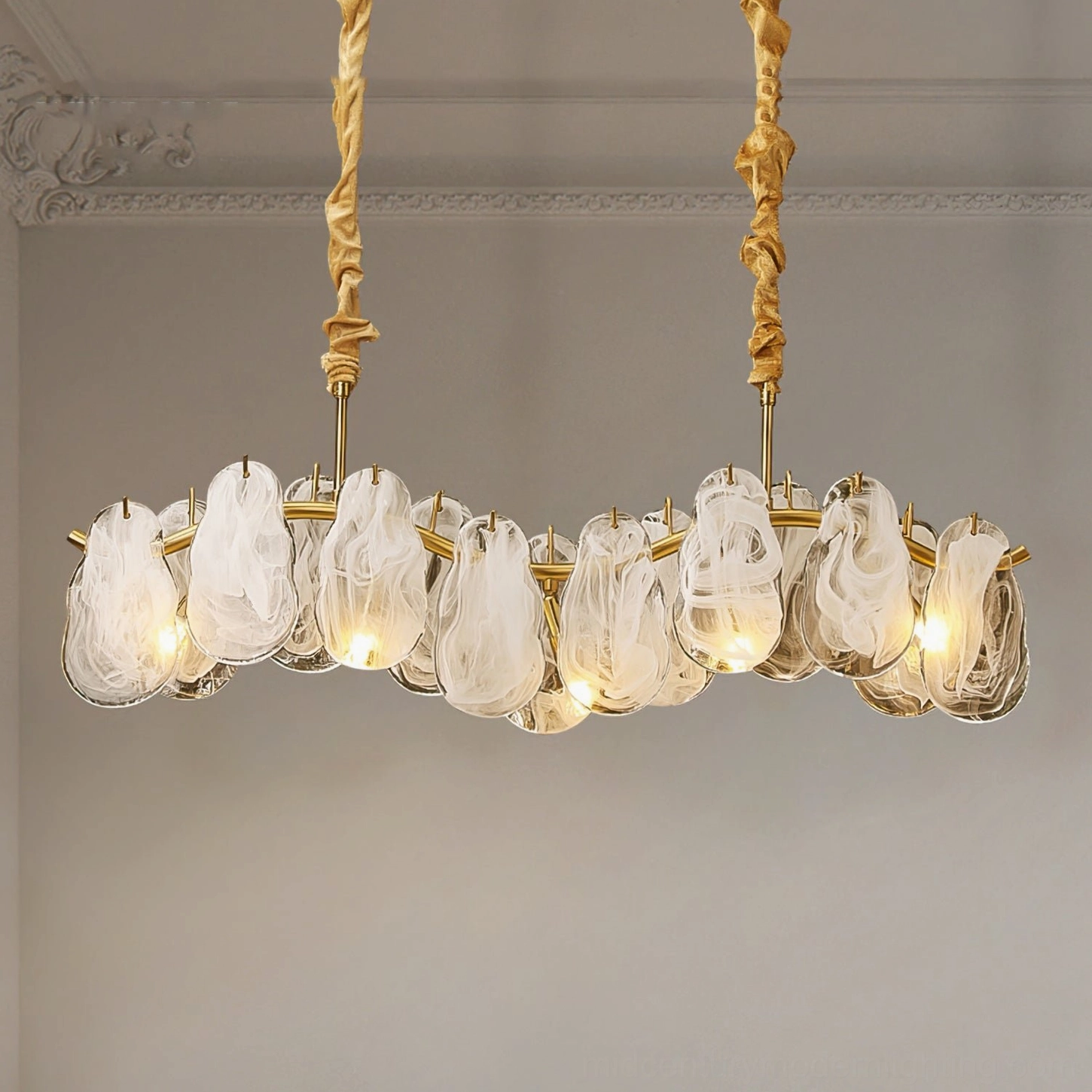 Cloud glass chandelier pendant installed in formal dining room with twisted fabric suspension cord and eye-level side view showcasing architectural details