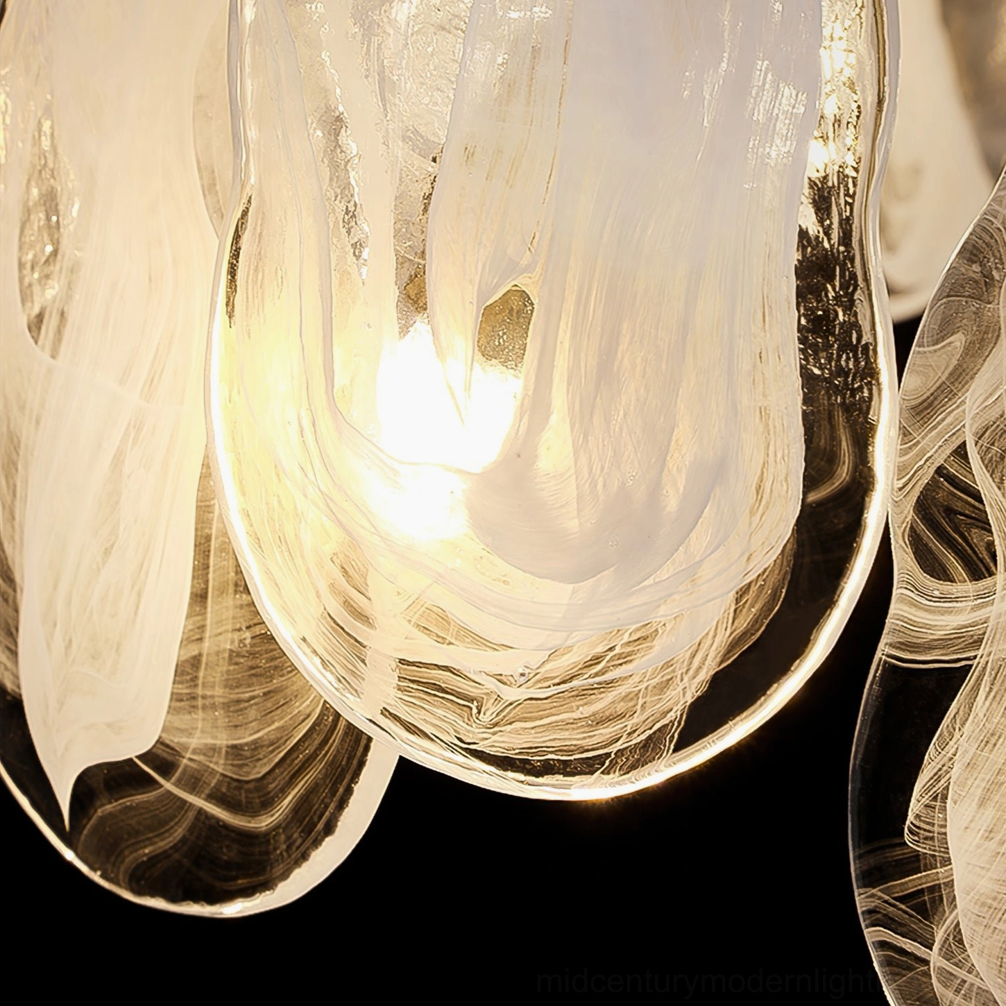 Fluid ripple glass texture detail of Mahina Cloud chandelier shade with integrated warm LED lighting and organic cloud pattern
